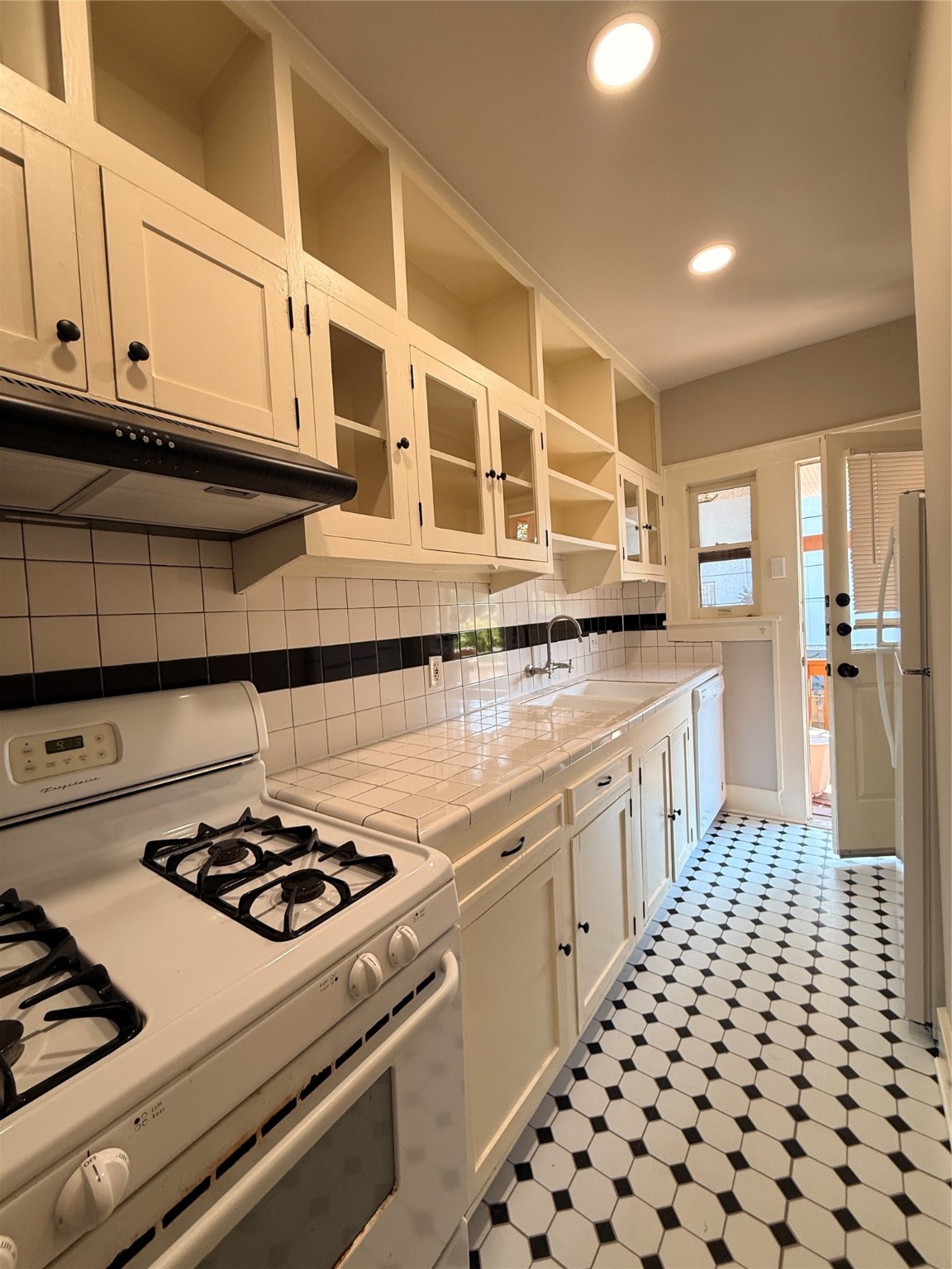 1201 West Gray Street, Unit 3 Houston, TX 77019 - Photo 13 of 14 a kitchen with a stove and white cabinets