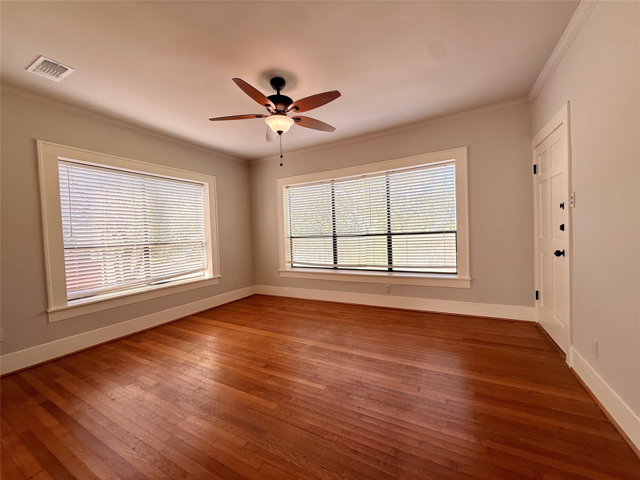 1201 West Gray Street, Unit 3 Houston, TX 77019 - Photo 3 of 14 a view of an empty room with wooden floor and a window