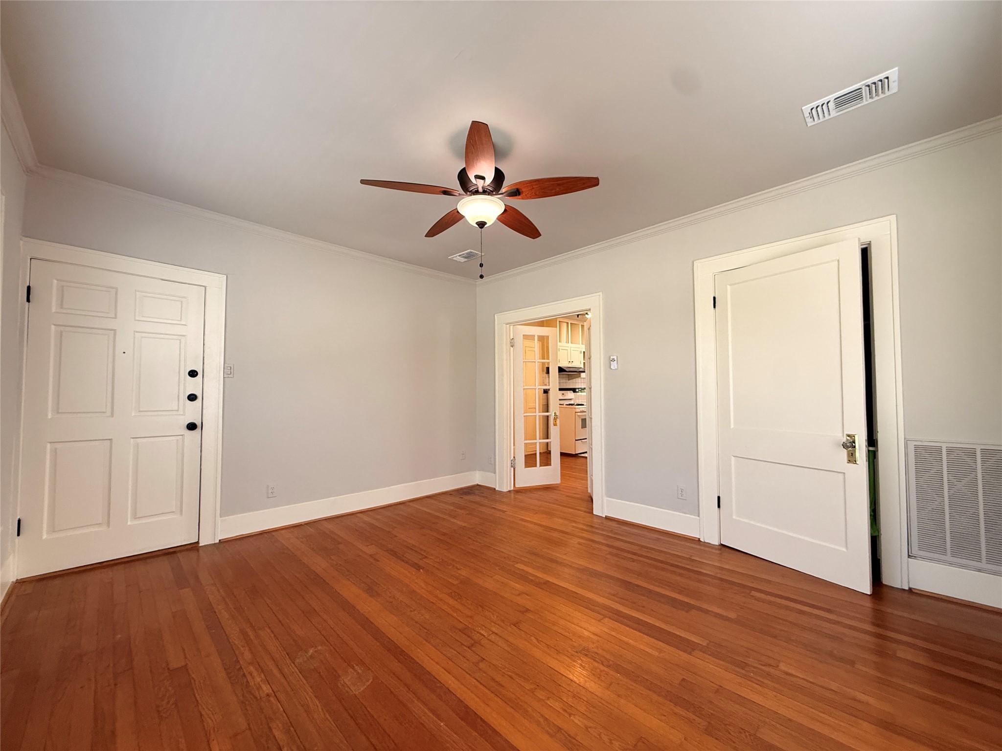 1201 West Gray Street, Unit 3 Houston, TX 77019 - Photo 4 of 14 a view of empty room with wooden floor and fan