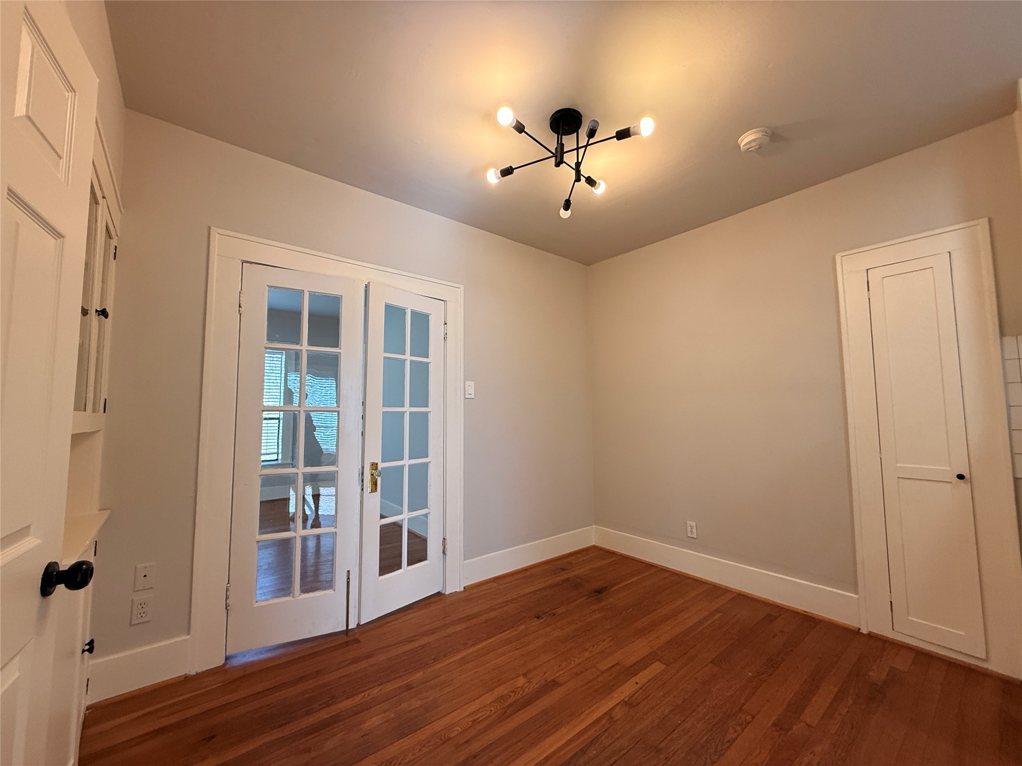 1201 West Gray Street, Unit 3 Houston, TX 77019 - Photo 6 of 14 wooden floor in an empty room with a window