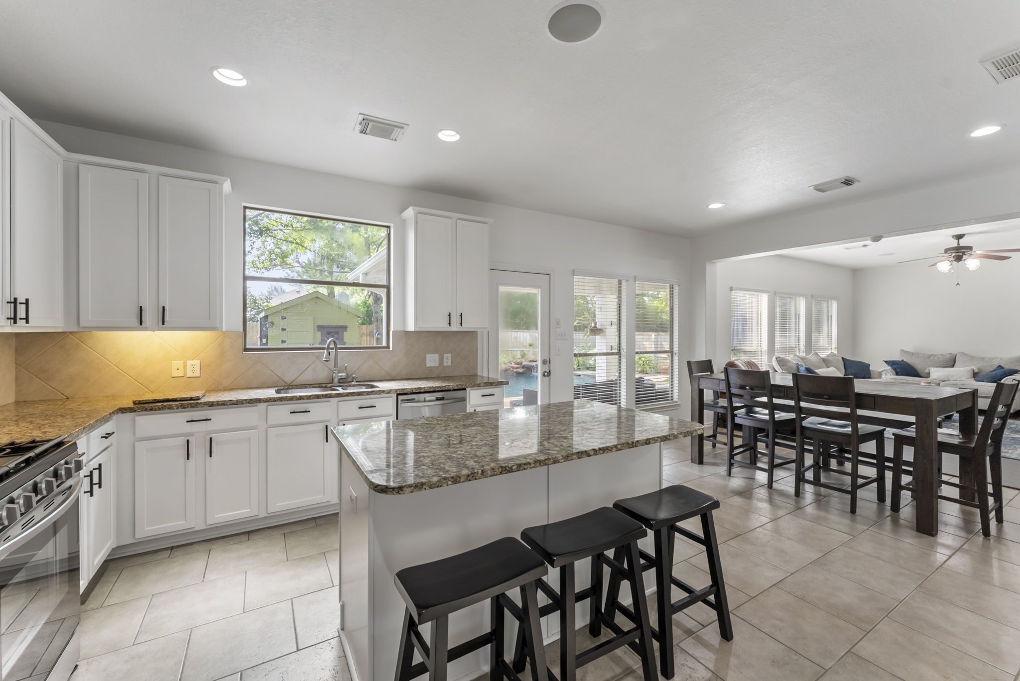 2106 Leaf Meadows Court Spring, TX 77386 - Photo 13 of 34 a large kitchen with lots of furniture a sink appliances and dining table
