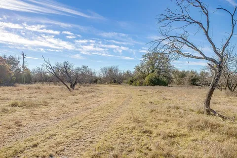 a view of yard covered with snow in the background