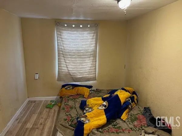 a bed sitting in a bedroom next to a window