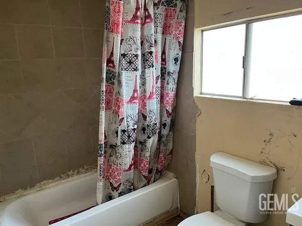 a bathroom with a toilet and shower