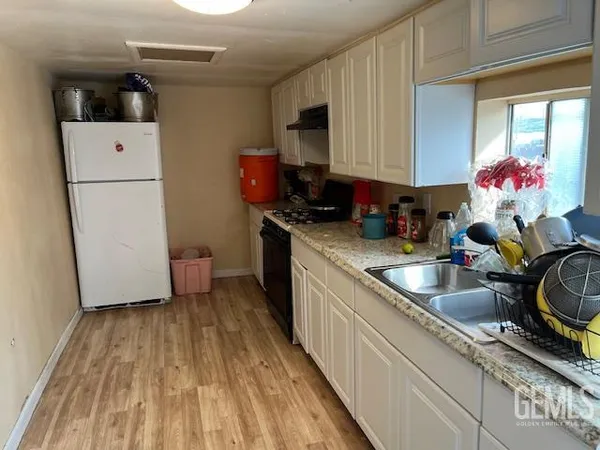 a kitchen that has a sink and a stove in it