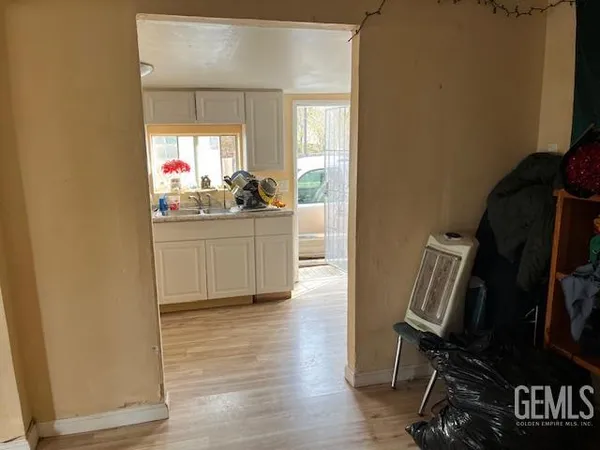 a kitchen with cabinets and a wooden floor