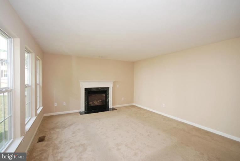 5976 Florey Road Hanover, MD 21076 - Photo 26 of 30 an empty room with windows and fireplace