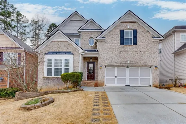 a front view of a house with a yard and garage