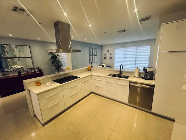 a kitchen that has a sink and a stove