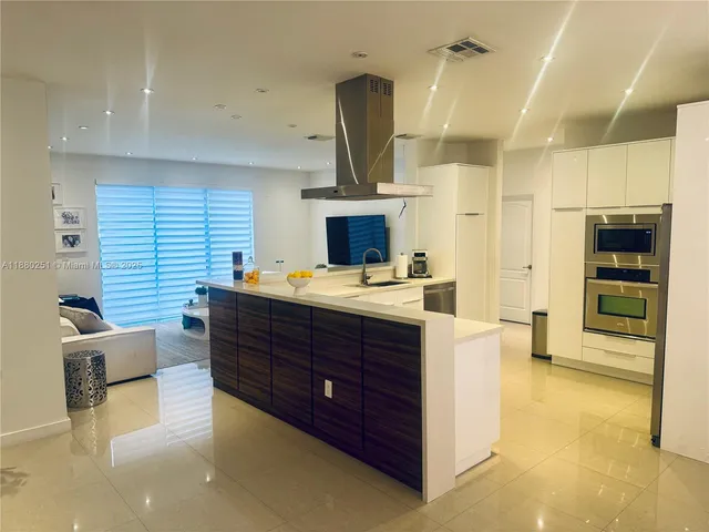 a room with furniture and large windows