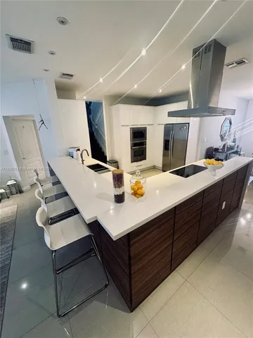 a kitchen with a sink a counter top space and appliances