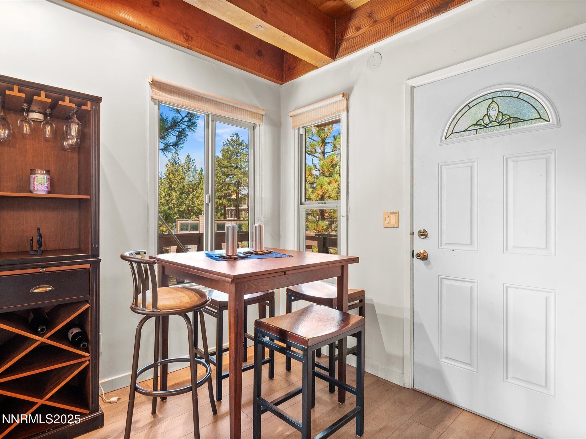 259 Tramway Drive, Unit 3 Stateline, NV 89449 - Photo 12 of 29 a view of a dining room with furniture window and wooden floor