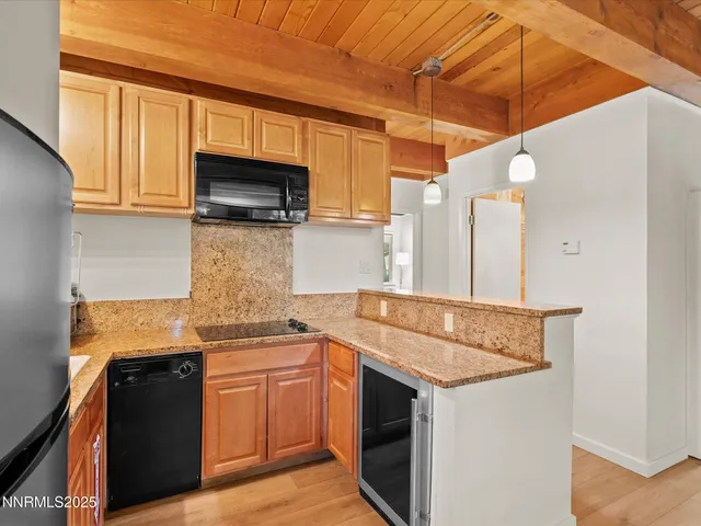 a kitchen with granite countertop a sink and a stove
