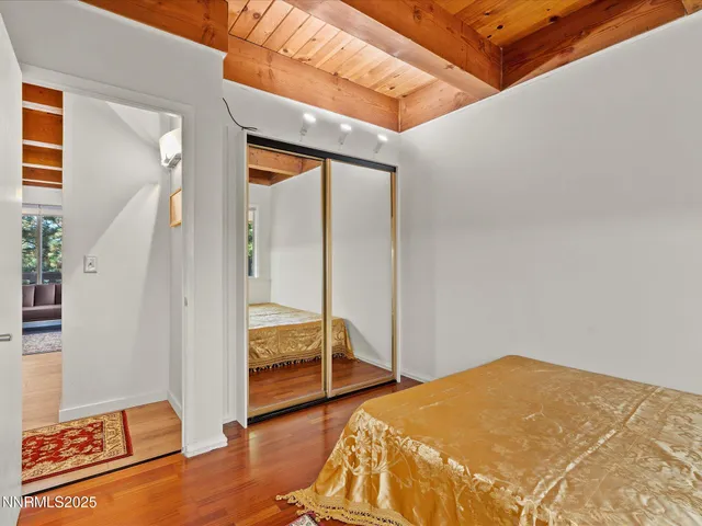 a bedroom with a bed and a mirror