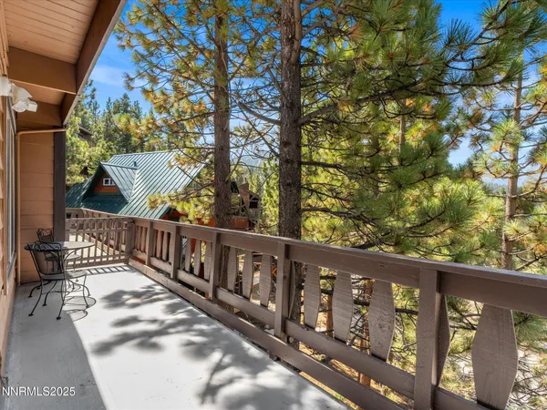a view of wooden balcony with furniture