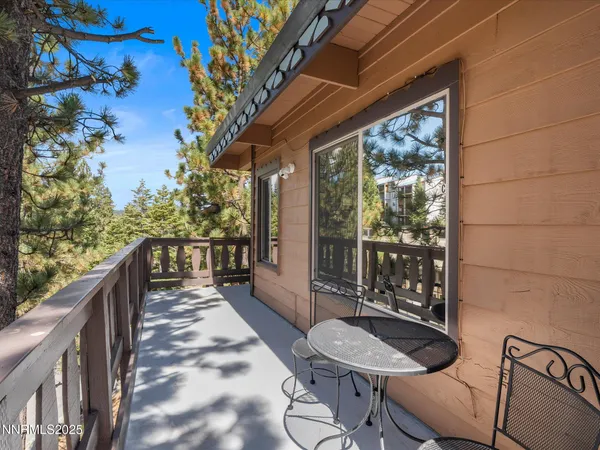 a balcony with wooden floor and furniture
