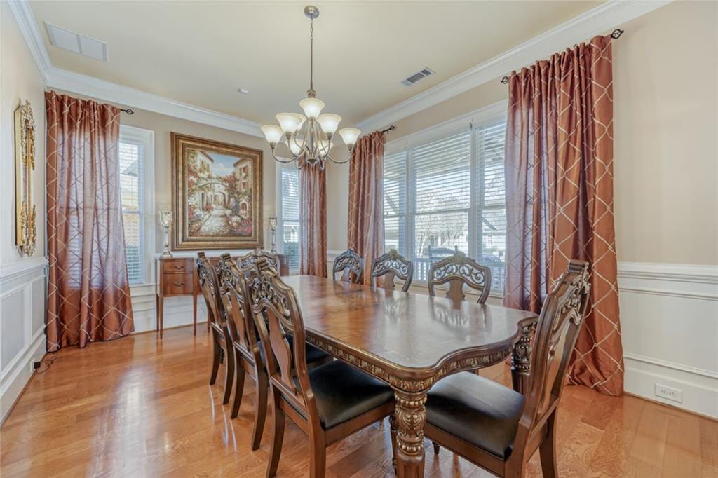 2380 Muskogee Lane Braselton, GA 30517 - Photo 8 of 30 a dining room with furniture a chandelier and wooden floor
