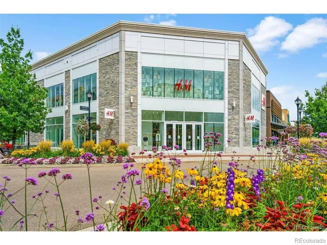 a front view of a house with a yard and fountain