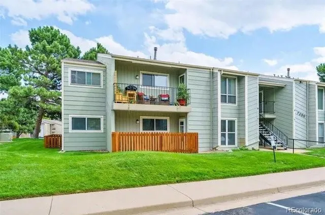 a front view of a house with a garden and yard