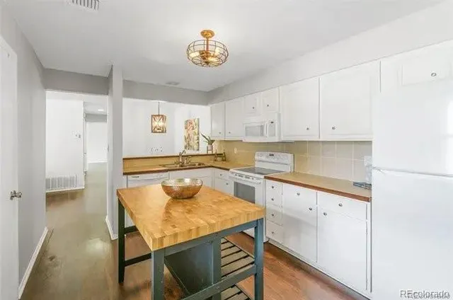 a kitchen with a table and chairs in it