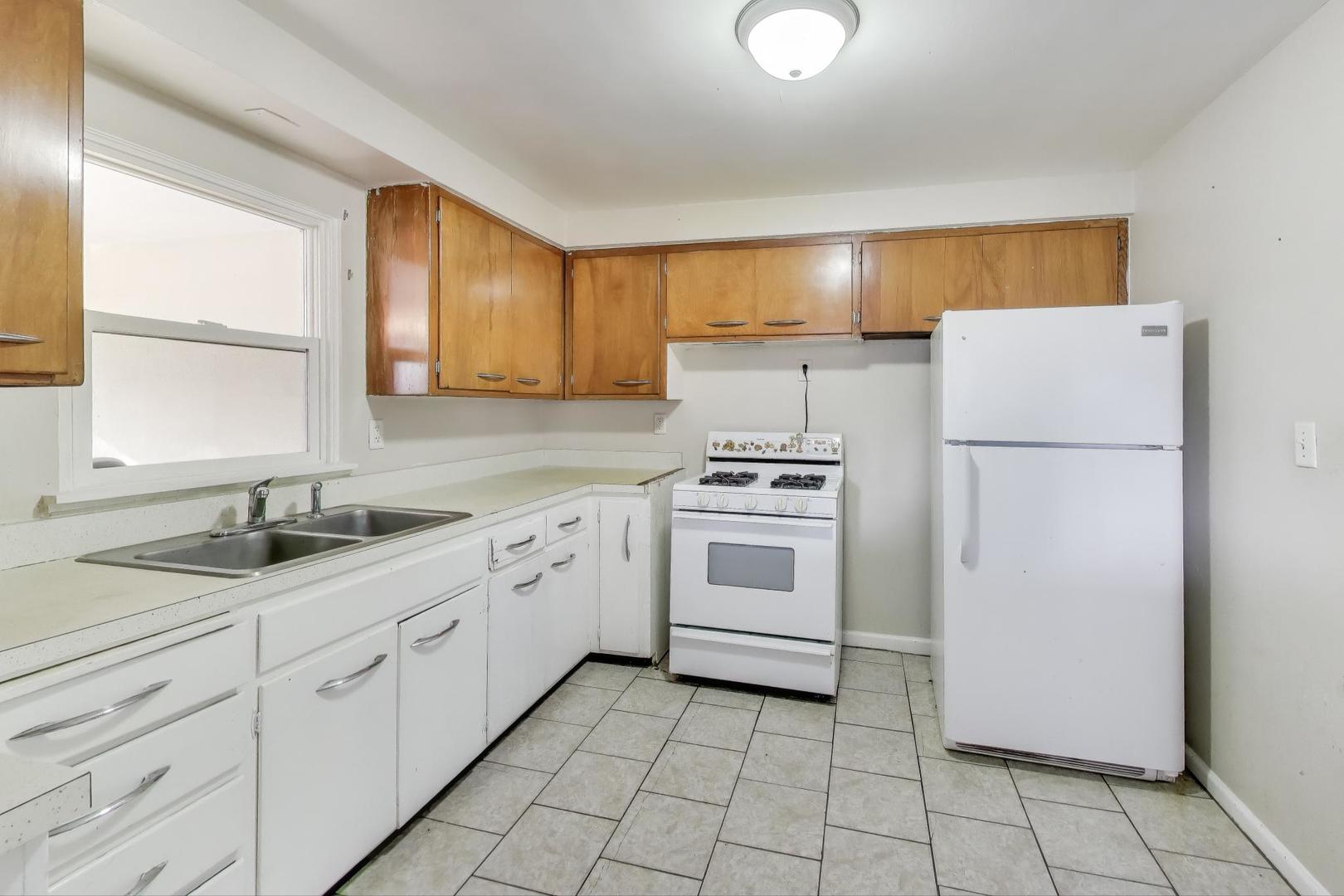 2524 Gilboa Avenue Zion, IL 60099 - Photo 13 of 33 a kitchen with white cabinets and white appliances