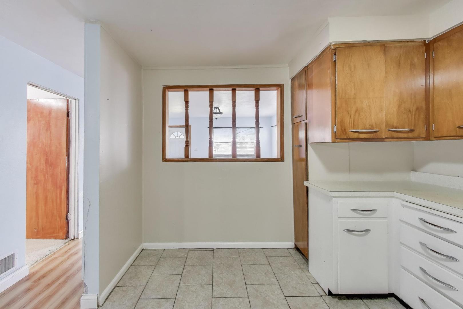 2524 Gilboa Avenue Zion, IL 60099 - Photo 14 of 33 a view of a kitchen with white cabinets and a window
