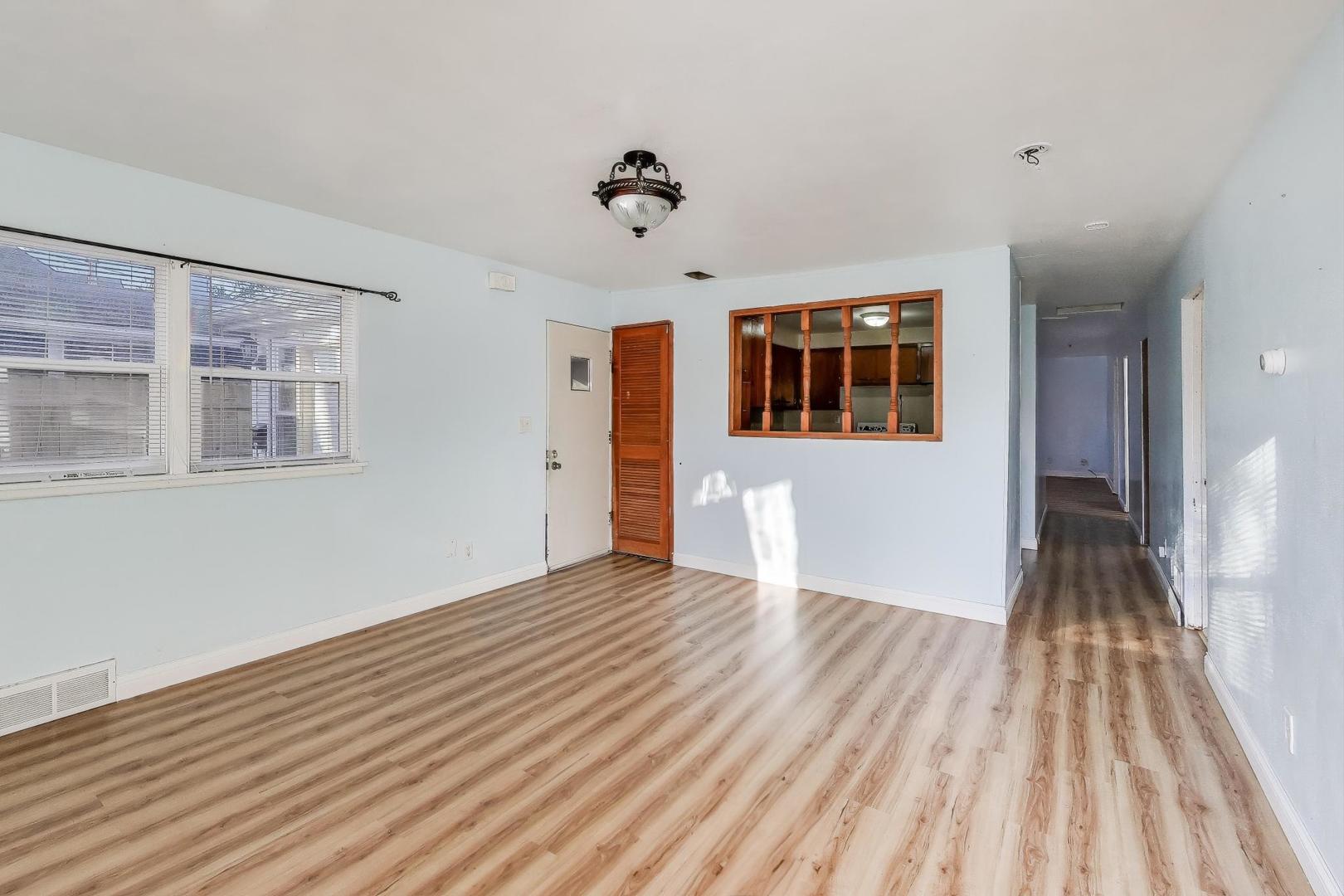 2524 Gilboa Avenue Zion, IL 60099 - Photo 6 of 33 wooden floor in an empty room with a window