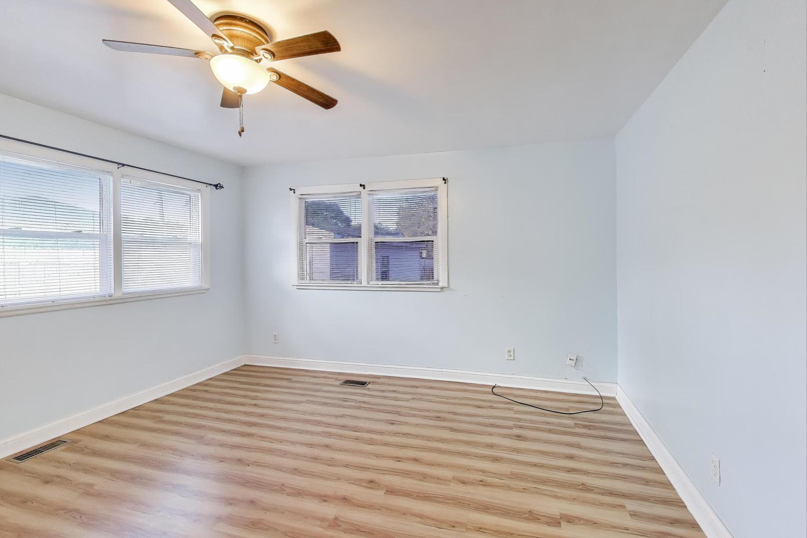 2524 Gilboa Avenue Zion, IL 60099 - Photo 9 of 33 a view of empty room with wooden floor and fan
