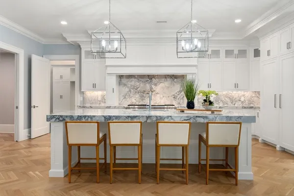 a kitchen with center island table and chairs in it