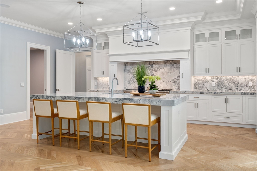 196 Pond Road Wellesley, MA 02482 - Photo 5 of 20 a kitchen with center island table and chairs in it