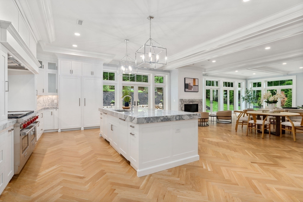 196 Pond Road Wellesley, MA 02482 - Photo 8 of 20 a large white kitchen with lots of counter space and chandelier