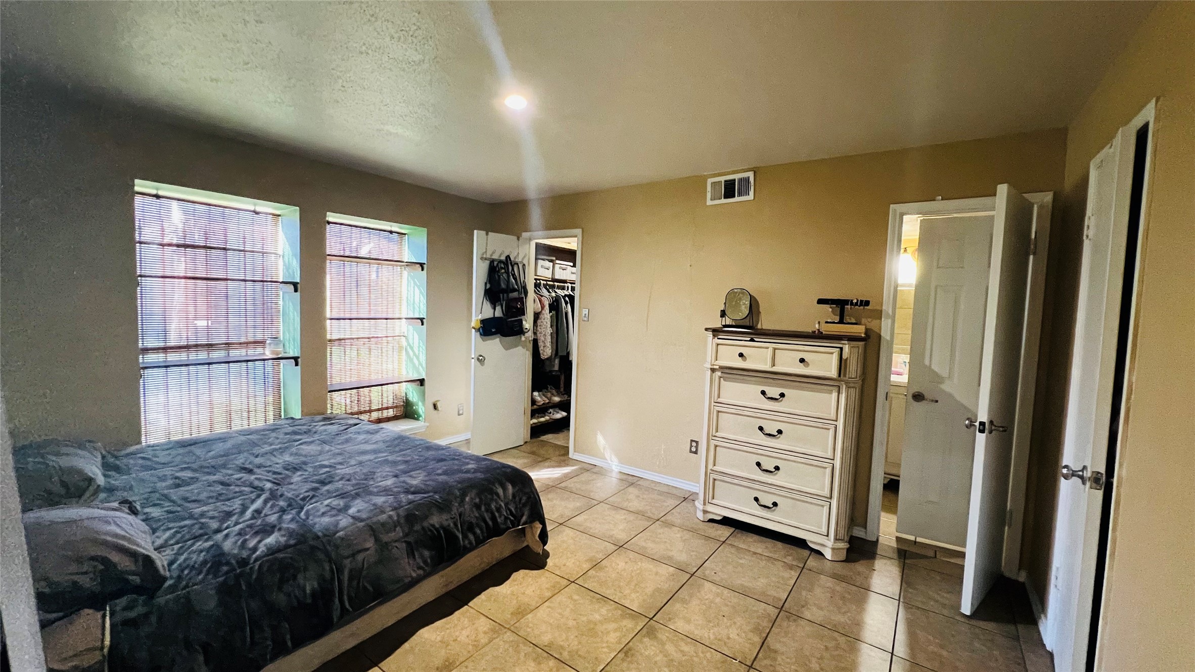 12222 Wild Pine Drive, Unit C Houston, TX 77039 - Photo 4 of 9 a bedroom with a bed and a window