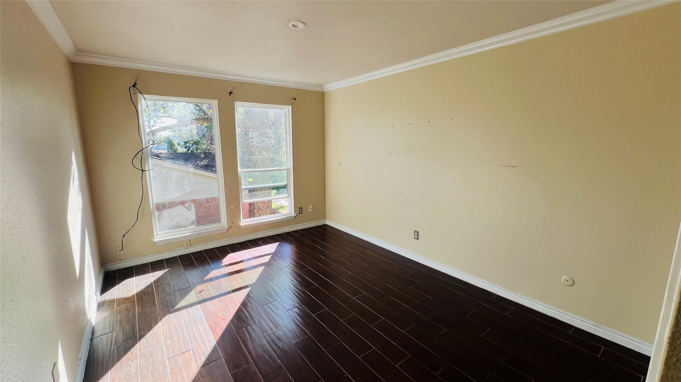 12222 Wild Pine Drive, Unit C Houston, TX 77039 - Photo 5 of 9 a view of an empty room with wooden floor and a window