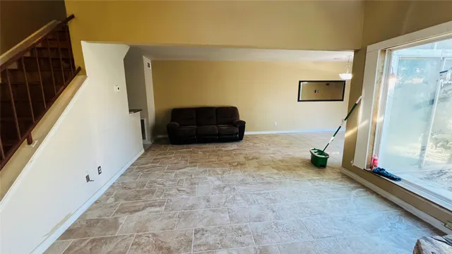 a kitchen with a granite countertop sink and cabinets