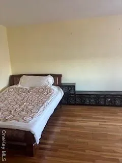 a bedroom with a bed and a night stand