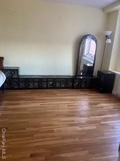 a view of a room with wooden floor