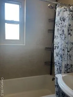 a bathroom with a bathtub and shower