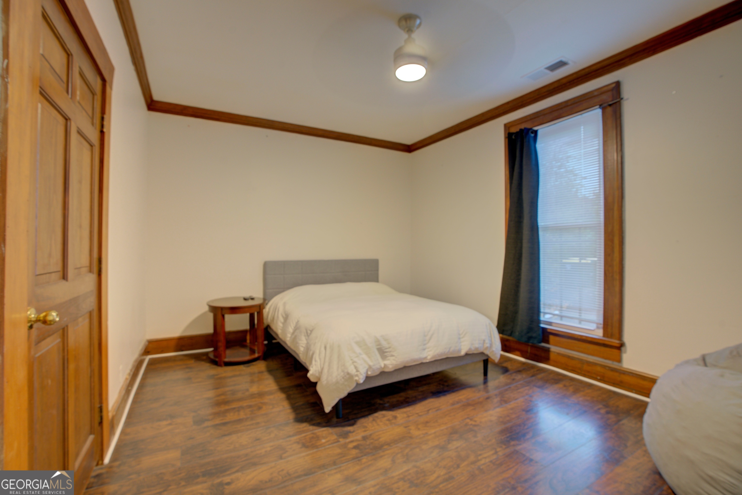 232 South Broad Street Rome, GA 30161 - Photo 14 of 37 a bedroom with a bed and wooden floor