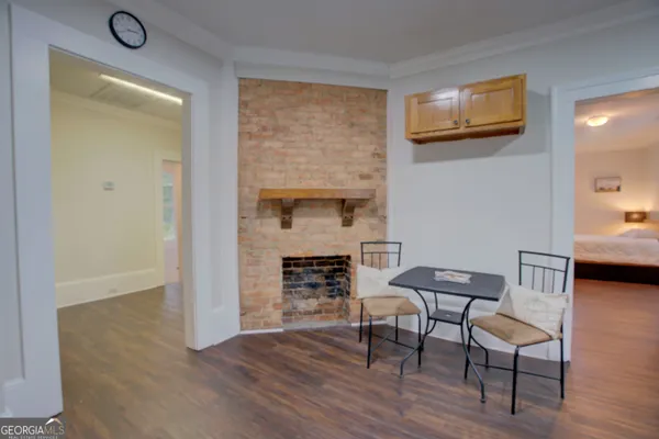 a view of kitchen with wooden floor and electronic appliances