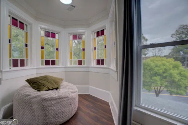 a view of a livingroom with workspace and a window