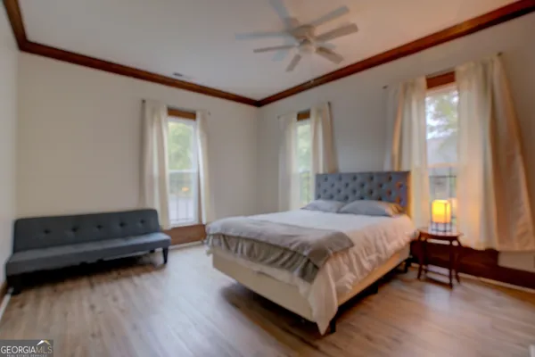 a bedroom with a bed and wooden floor