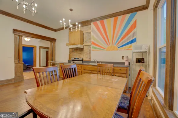 a dining room with furniture and a chandelier