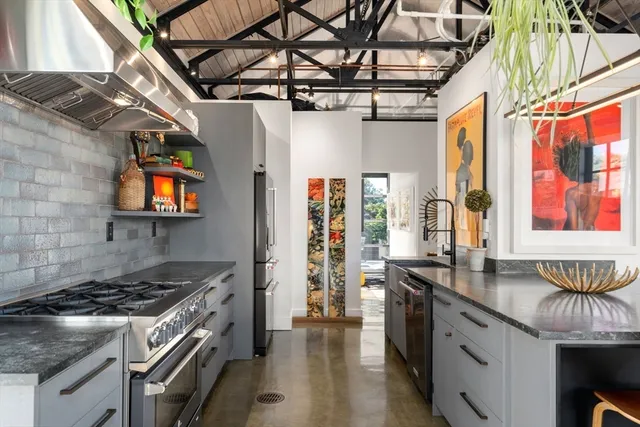 a kitchen with stainless steel appliances granite countertop a stove and a sink