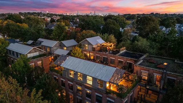 an aerial view of a house with a yard and mountain view