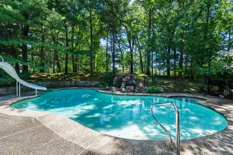 a view of a swimming pool in a backyard