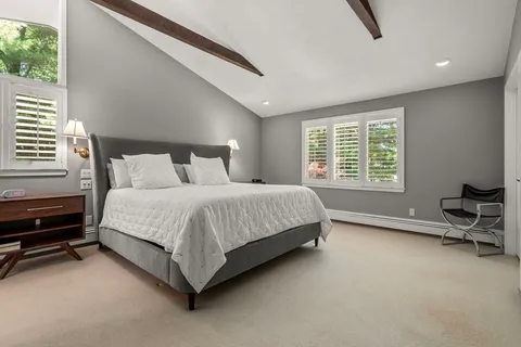 a bed room with a bed and a chair