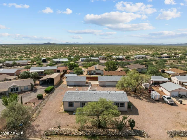 an aerial view of a houses with city view