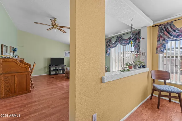 a view of a workspace with furniture and a window