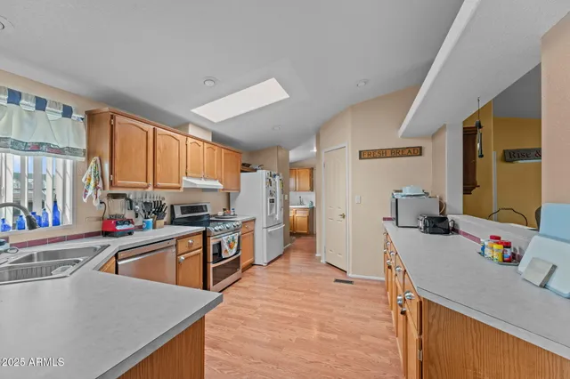 a kitchen with granite countertop a sink stove and cabinets