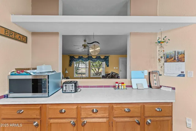 a kitchen with kitchen island granite countertop cabinets a sink and a stove